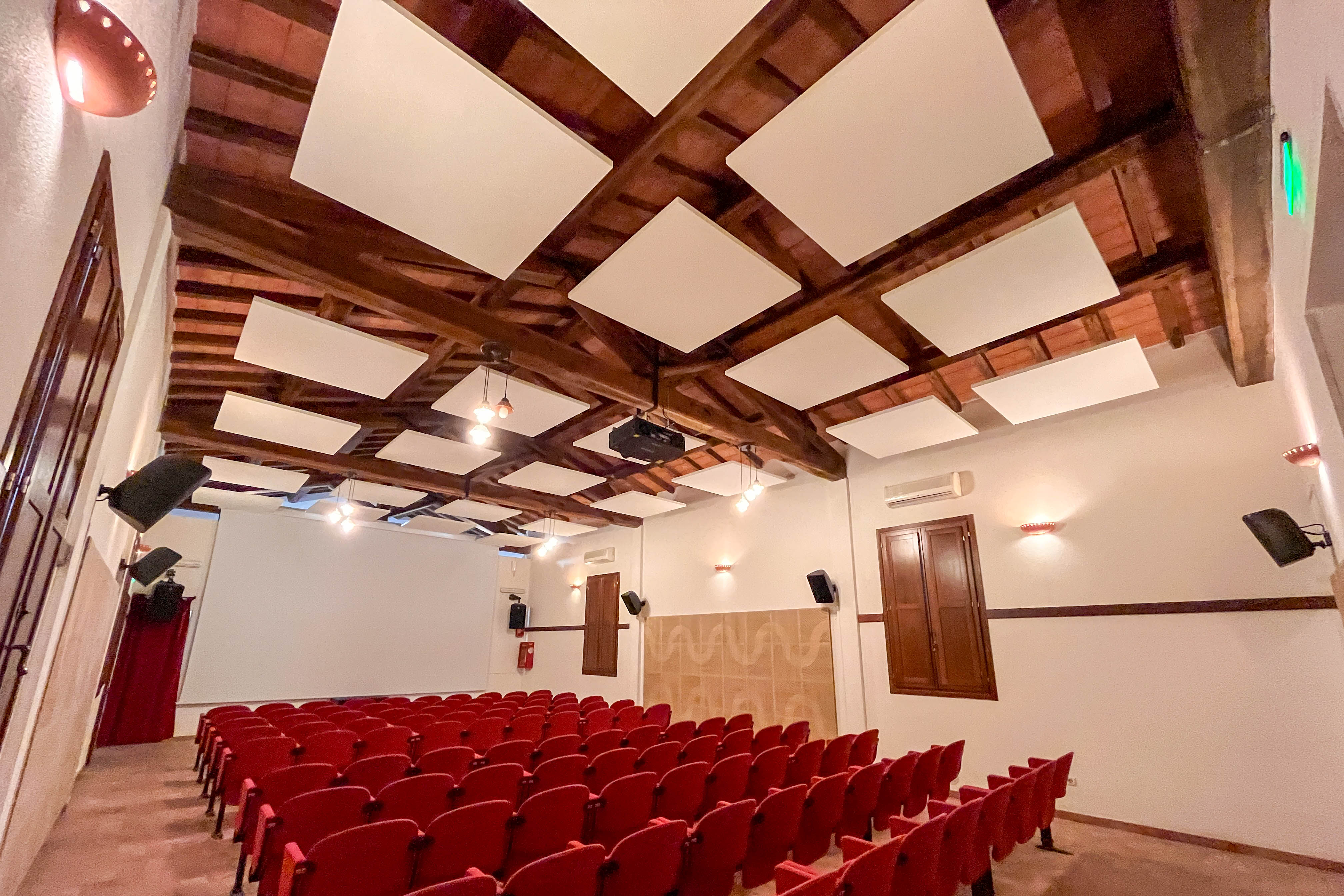 Acoustic ceiling baffles and rafts for auditoriums